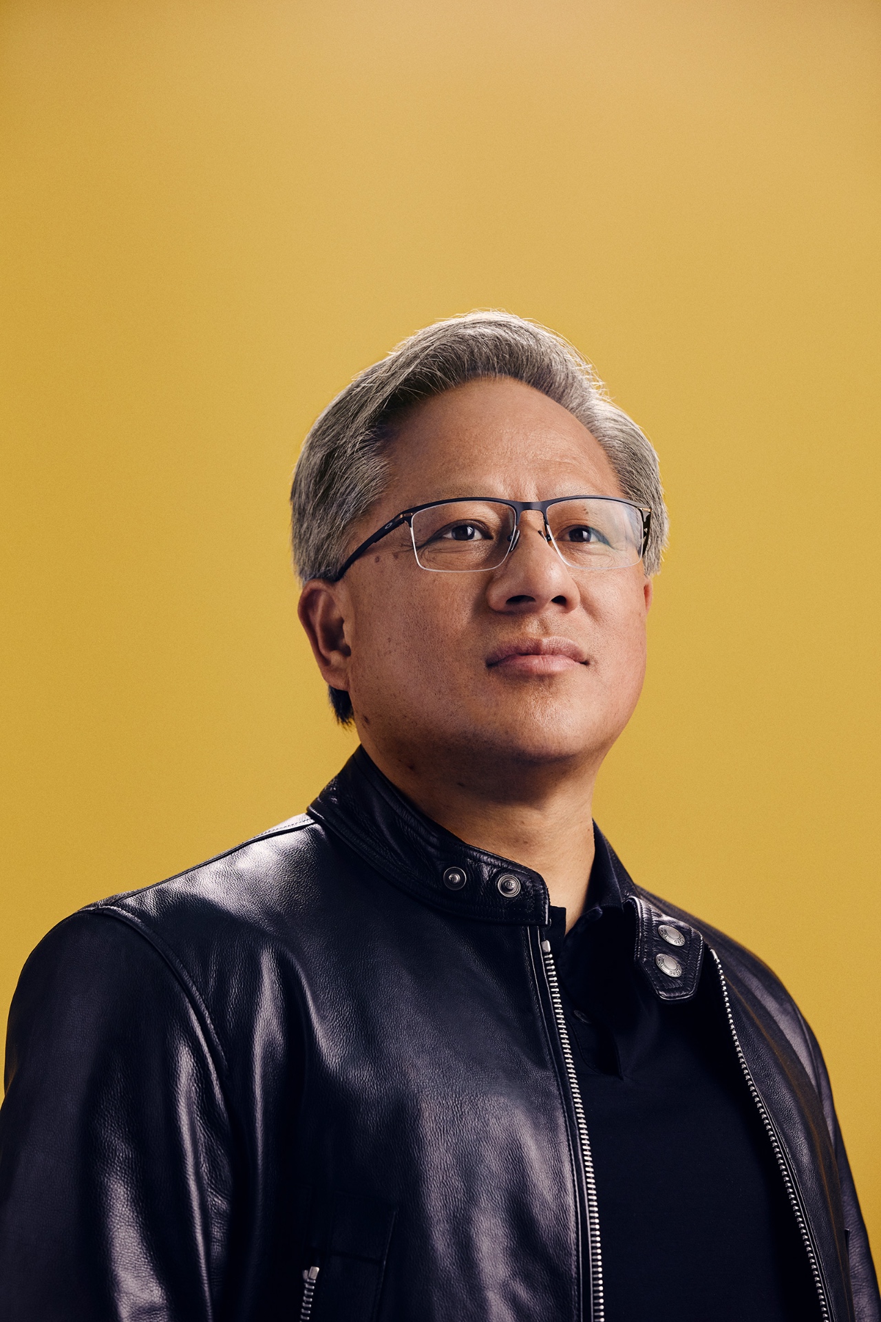 Portrait of Nvidia CEO Jensen Huang in a black leather jacket against a gold backdrop